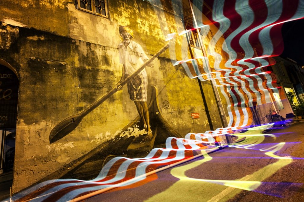 The light painting in this photo further reinforces that this street art is in Malaysia.