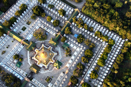 An overhead view of a temple with many stupa's, and one central golden stupa. The photo was taken from a hot air balloon. Myanmar, asia, travel, aerial photo, temple, stupa's, Buddhist, Simon Bond.