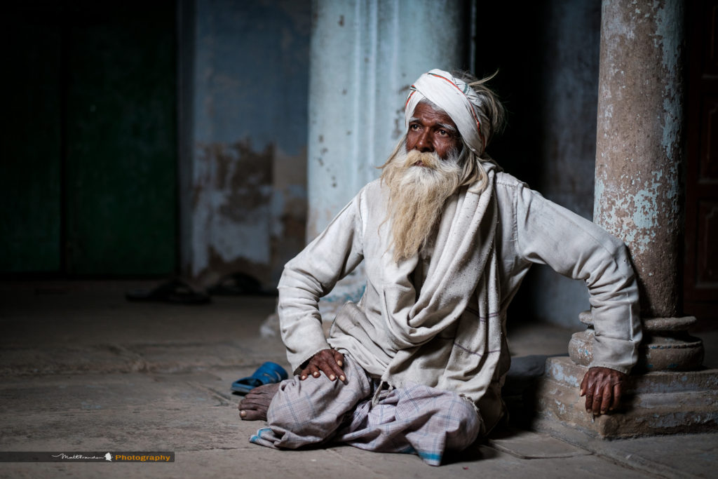 A Muslim, Faquir or holy man rests in the back streets on Varanasi, India. Copyright Matt Brandon.