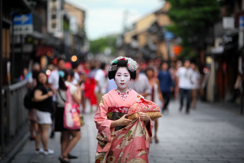 A Maiko walks along the street in Gion in Kyoto. This is one of the best creative photos Simon Bond took in 2018.
